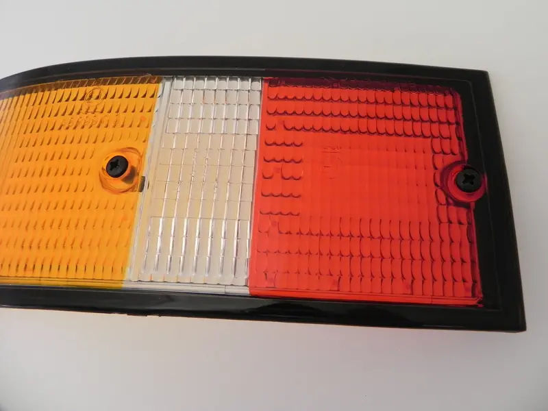 (New) 911/912/930 Genuine Left Side Euro Amber/Red/Clear Tail Light Lens With Black Trim - 1973-89 2
