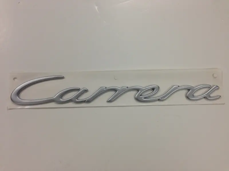 (New) 996 Silver "Carrera" Engine Lid Emblem - 1999-2004 1